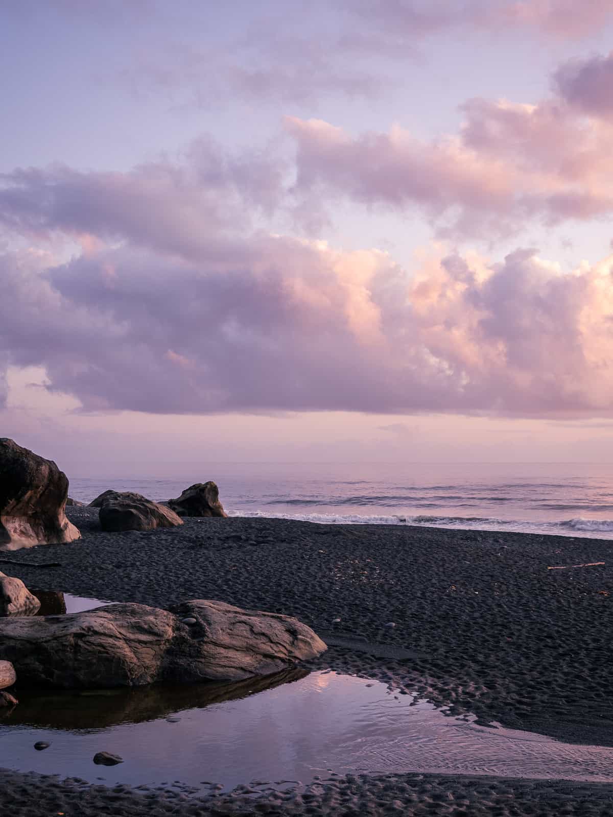 Sunset colors over a pool of water in sand