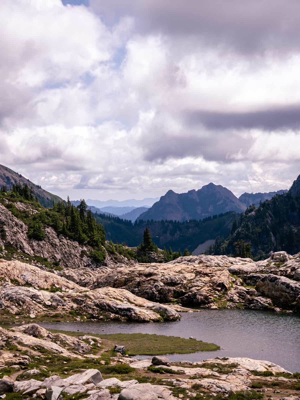 Layers of mountain ridges back up the view of a high altitude pond