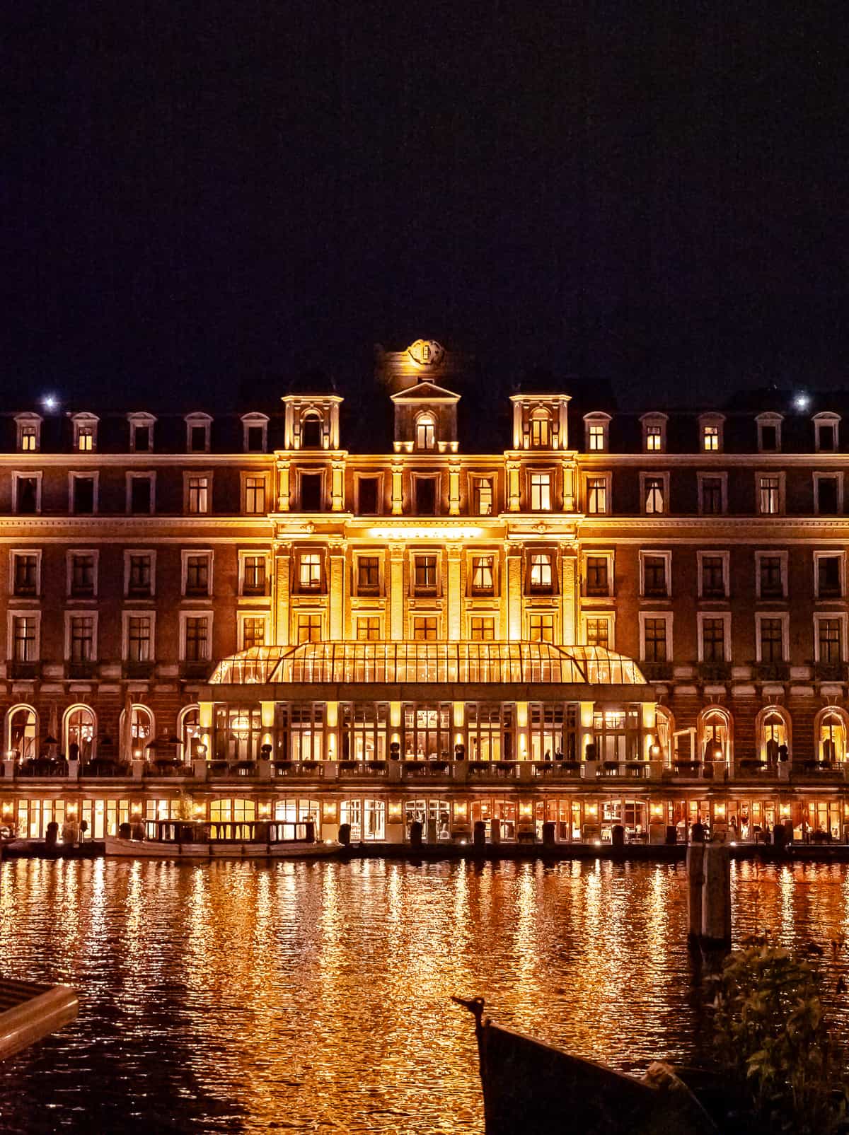 A large, well-lit nighttime view of a large, ornate old building