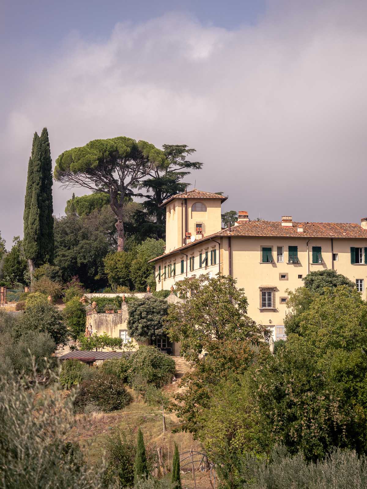 A villa basked in sunlight as morning fog fades