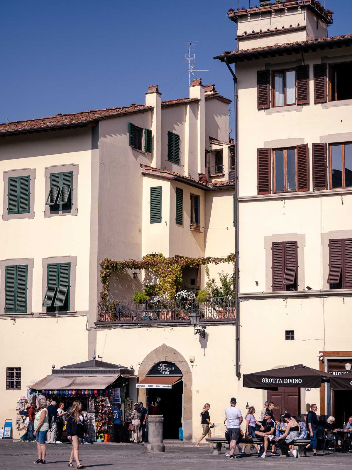 Tourists eat ice cream below a garden patio in Florence