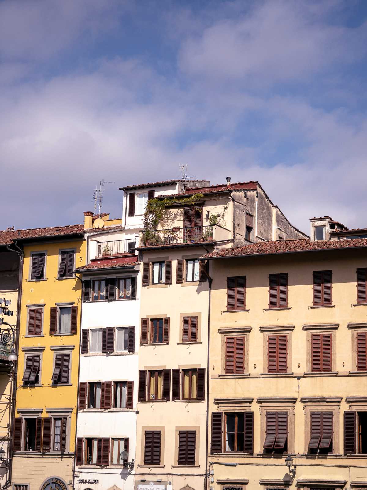 Old European style building shine in sunlight, a couple with rooftop garden