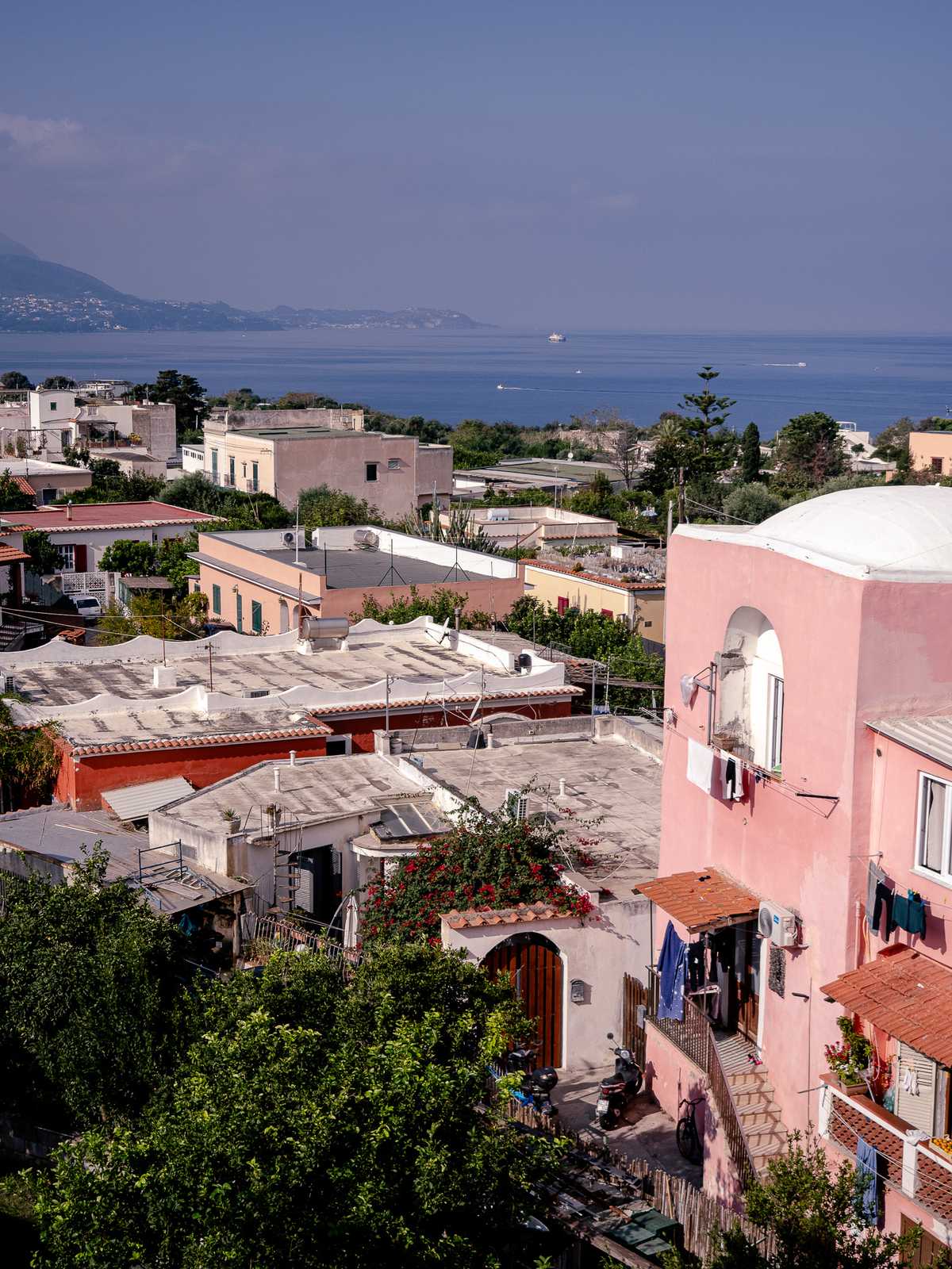 Coastal Italian building stretch forward with the ocean in the distance