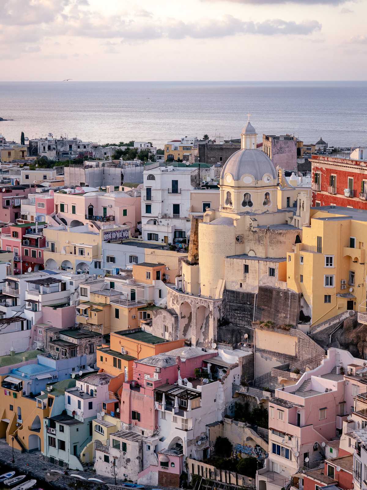 Colorful buildings reflect sunset light in Procida, Italy