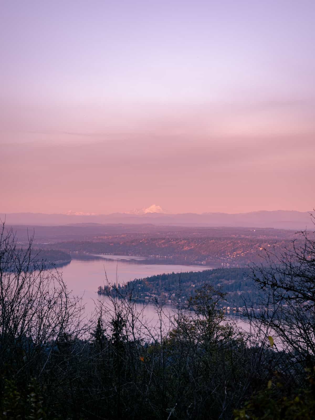 Sunset hues bask a view of Mount Baker in the distance with Lake Sammamish in the foreground