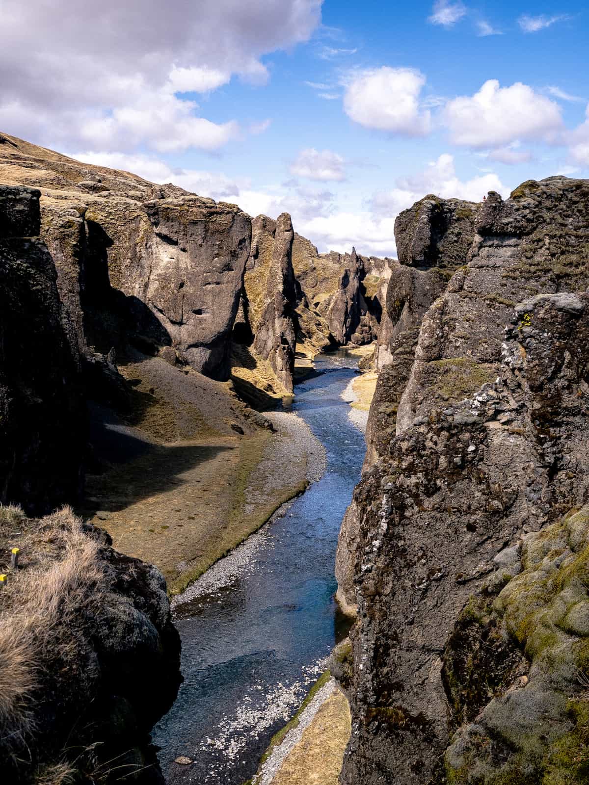 A serpent shaped canyon winds through a golden hillside