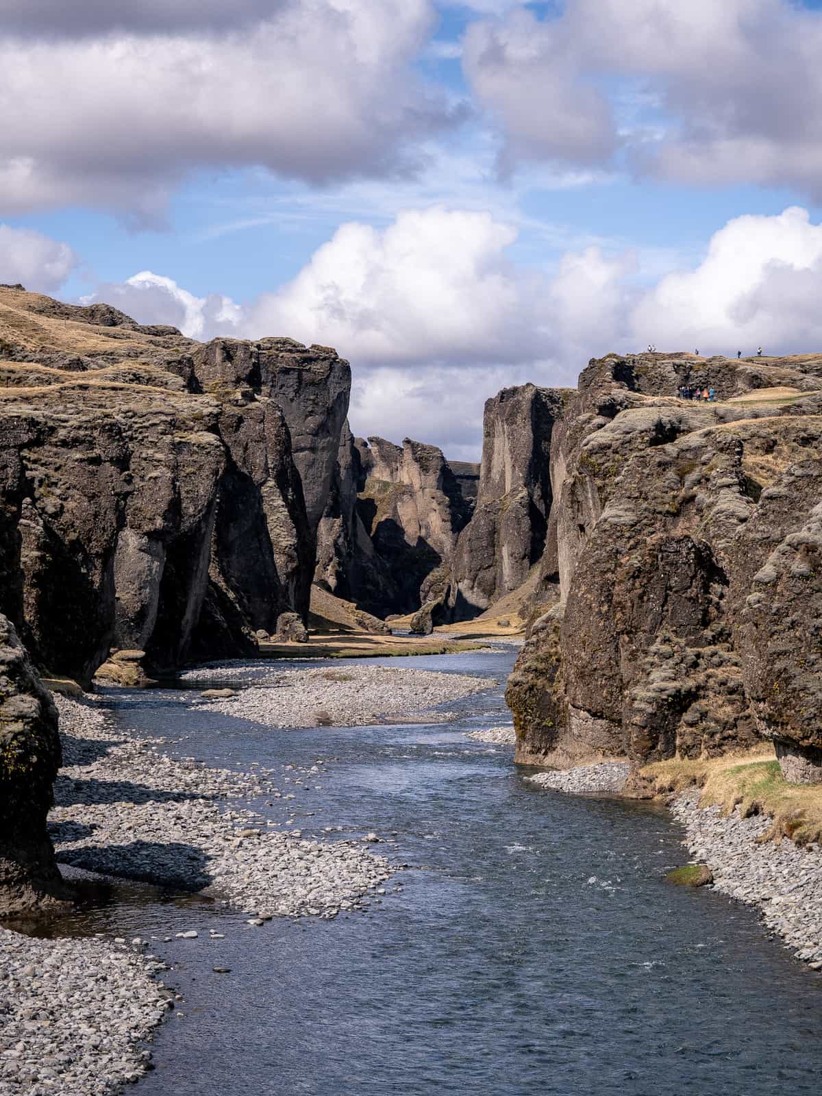 A serpent shaped canyon winds through a golden hillside, viewed from the front